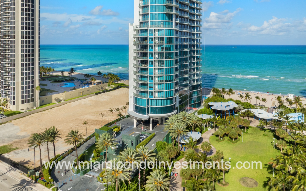 Chateau Beach Residences drone angle facing condo building lower exterior and entry