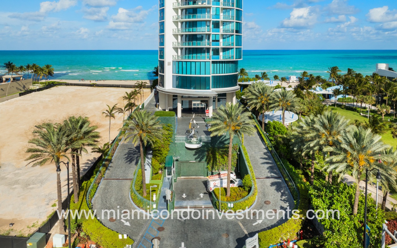Chateau Beach Residences drone directly facing lower front condo building exterior and entry