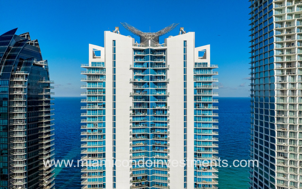 Jade Beach drone facing top half front of building with ocean backdrop