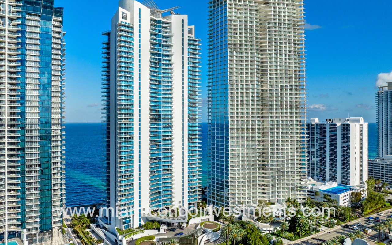 Jade Beach drone facing building with ocean backdrop