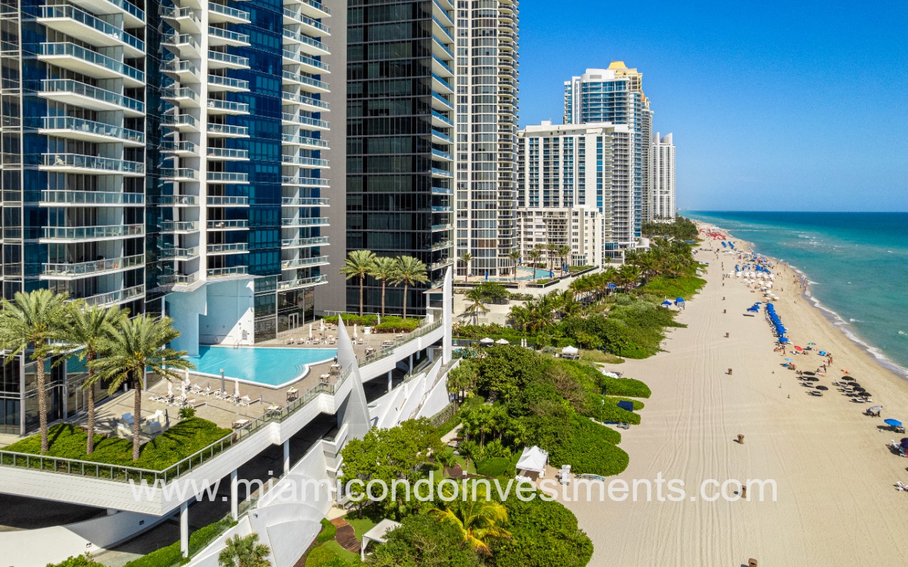 Jade Ocean condo building lower side profile of building with pool and shoreline