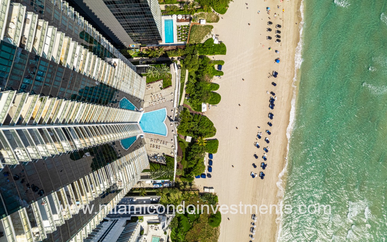 Jade Ocean condo building top downward view of pool and beach
