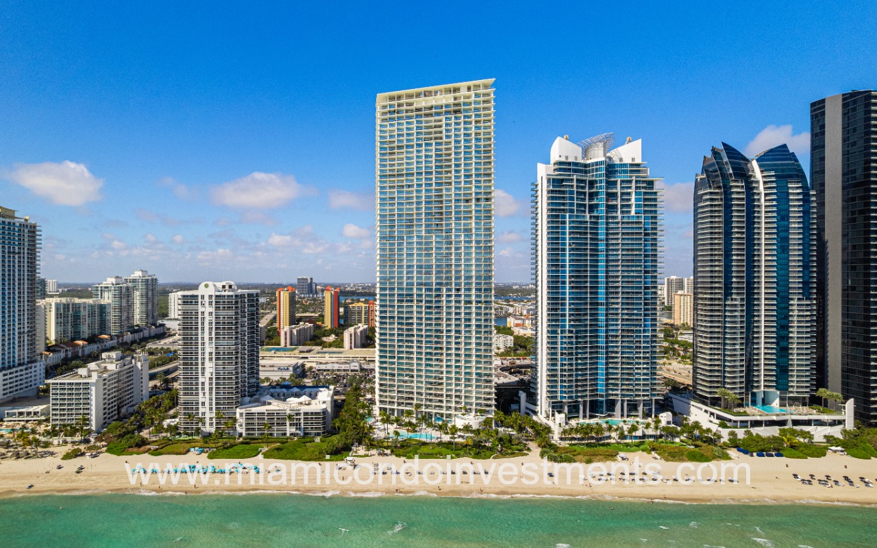 Jade Signature drone facing condo building and beach from ocean