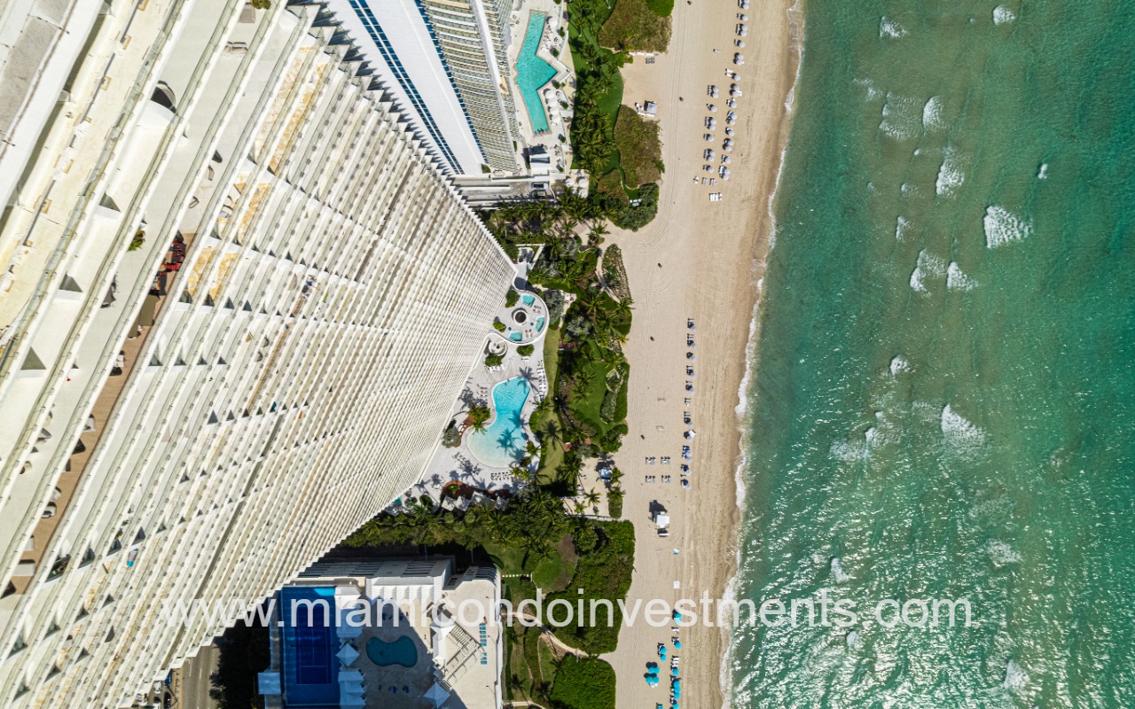 Jade Signature condos top downward view pool and beach shoreline