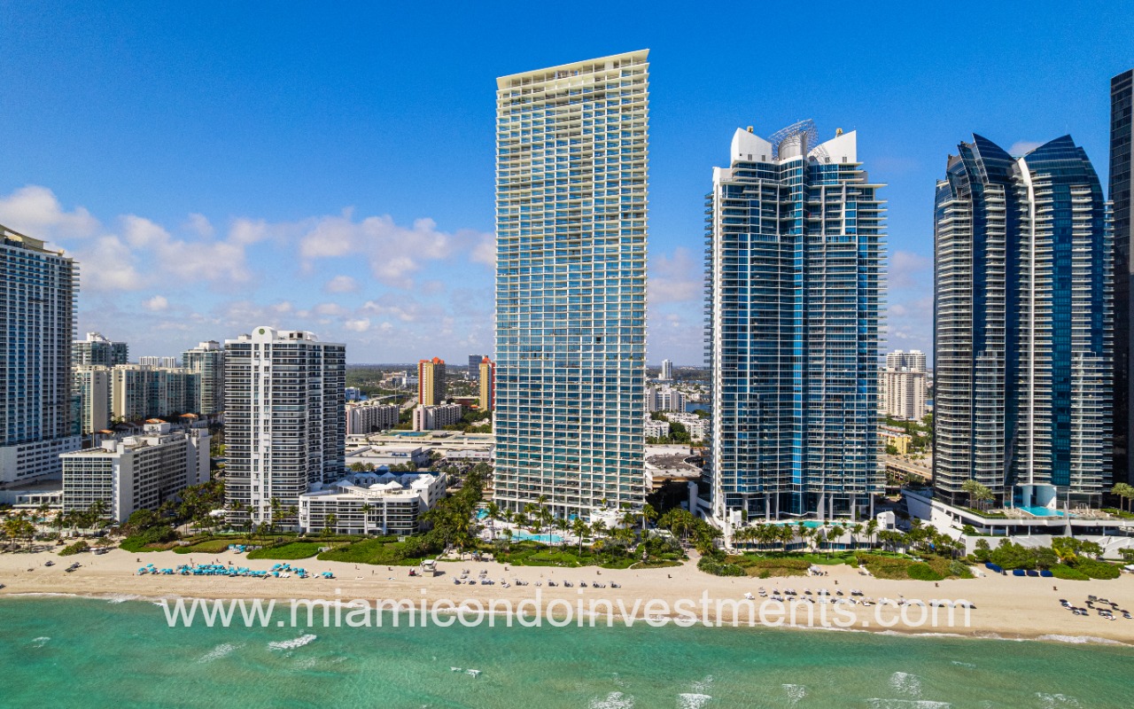 Jade Signature condos drone of building and beach from ocean