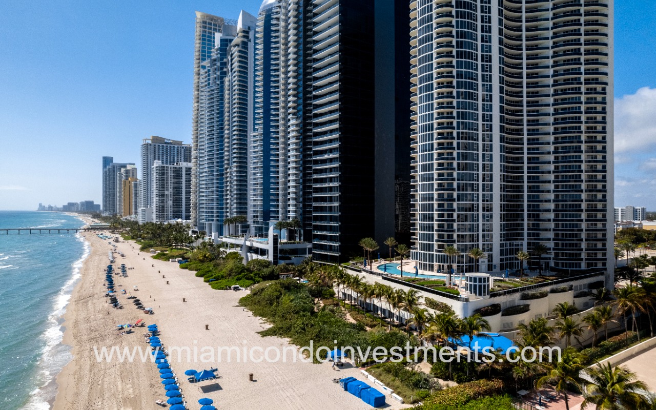 Ocean Four drone of condo building along beach shoreline