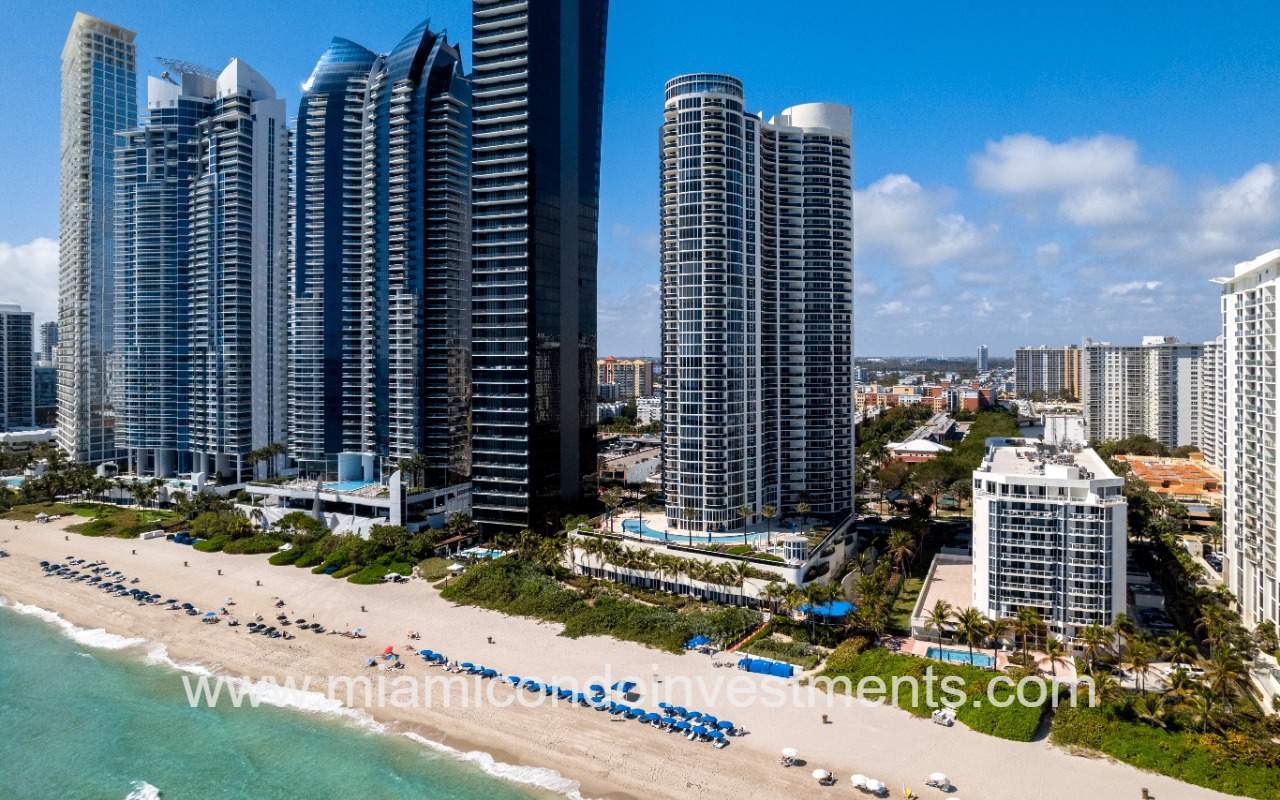 Ocean Four drone angled facing building and beach from ocean