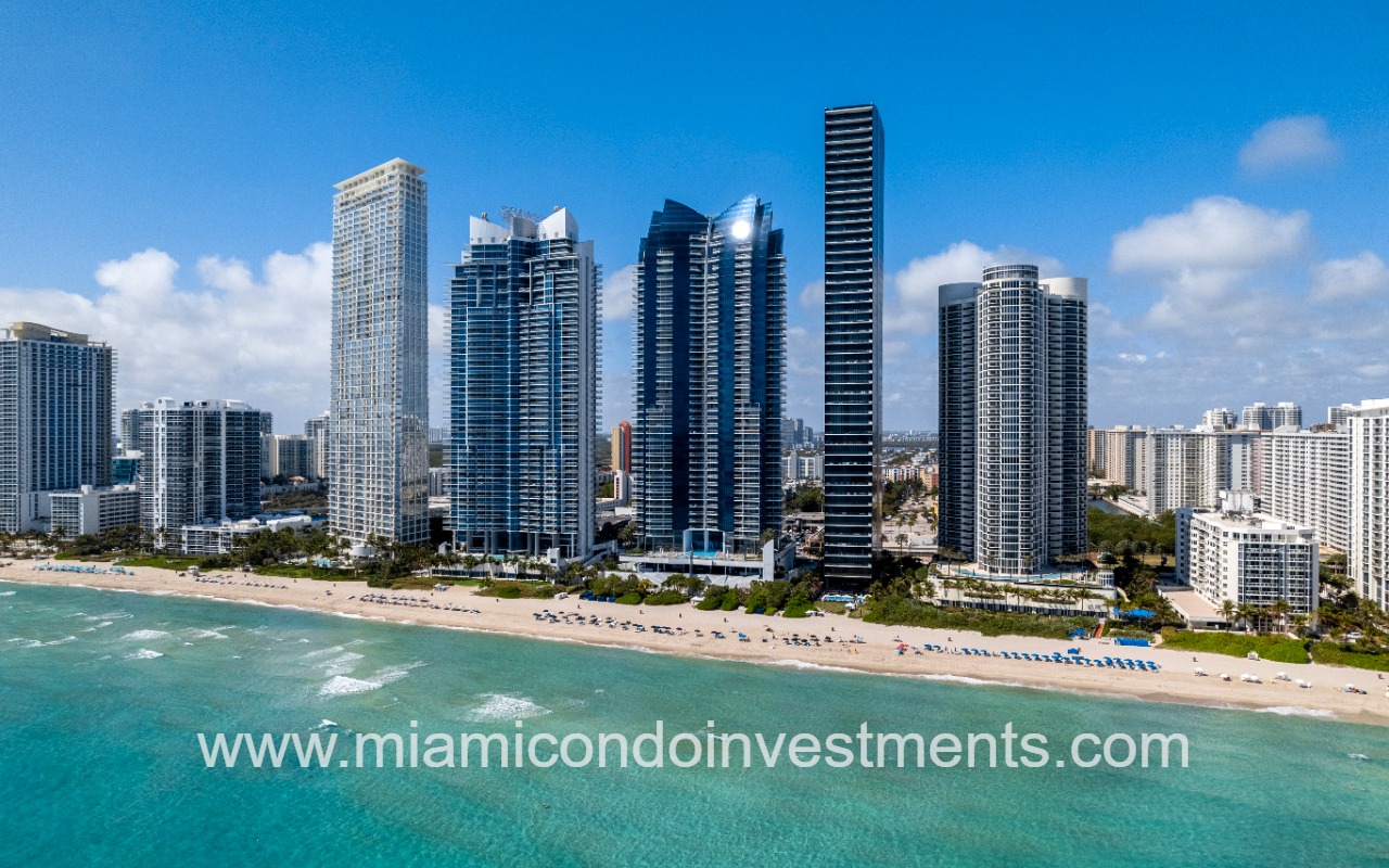 Ocean Four drone facing building and beach shoreline from ocean
