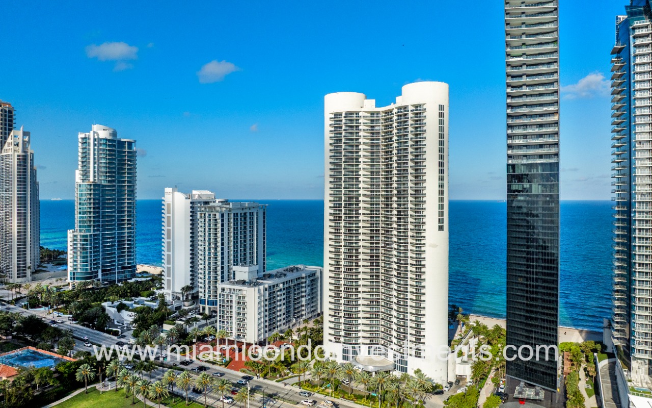 Ocean Four drone facing front angle of building with ocean backdrop