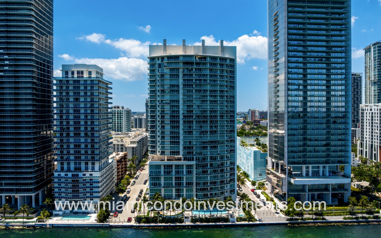 Onyx on the Bay drone directly facing the back of condo building from above the bay