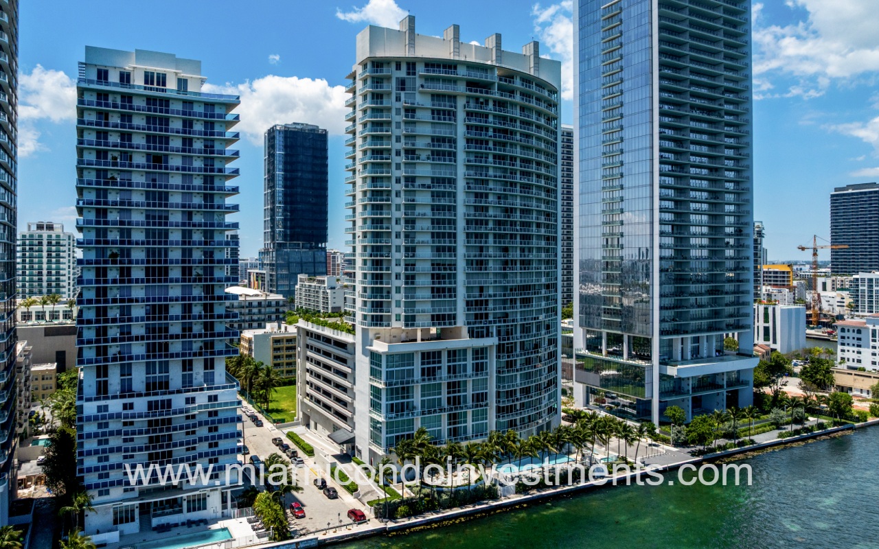Onyx on the Bay drone facing back of condo building from over the bay