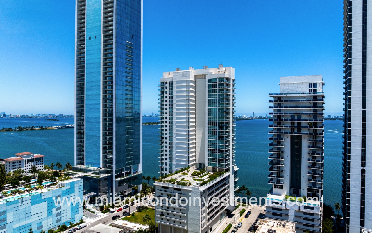 Onyx on the Bay drone facing the front of condo building with bay backdrop