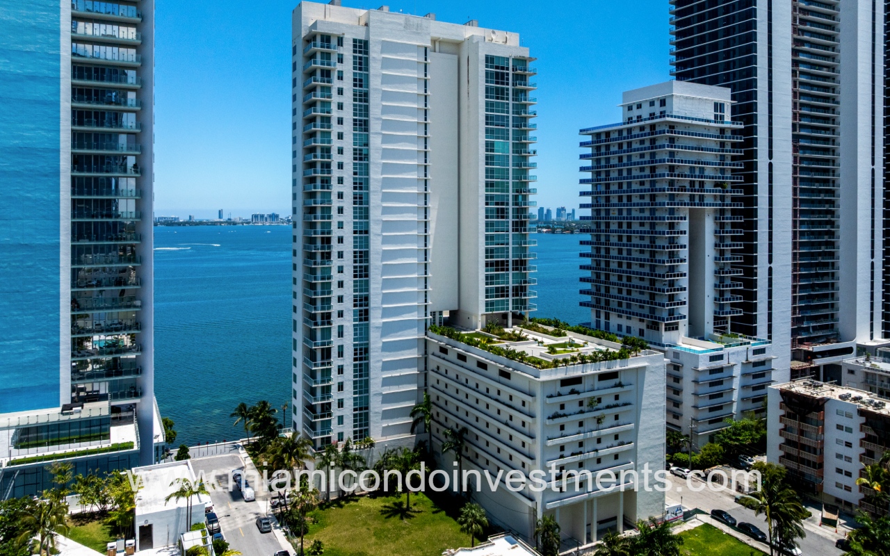 Onyx on the Bay drone angle view of the front of condo building with bay backdrop