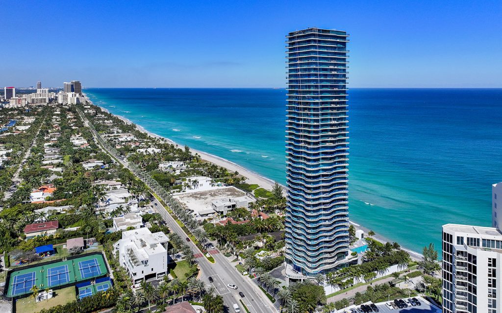 Regalia drone directly facing the condo building from above ocean
