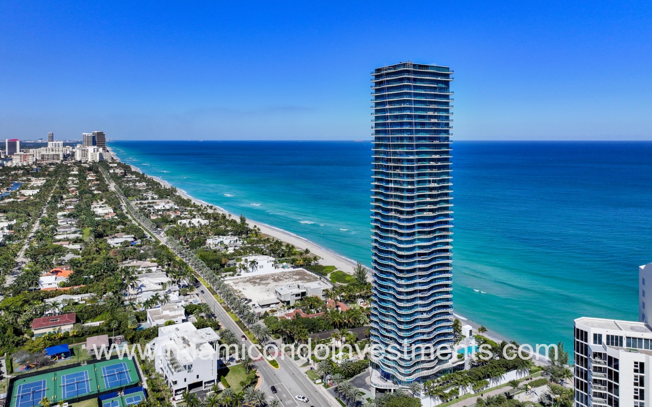 Ragalia drone view northward facing condo building exterior angle with blue ocean backdrop