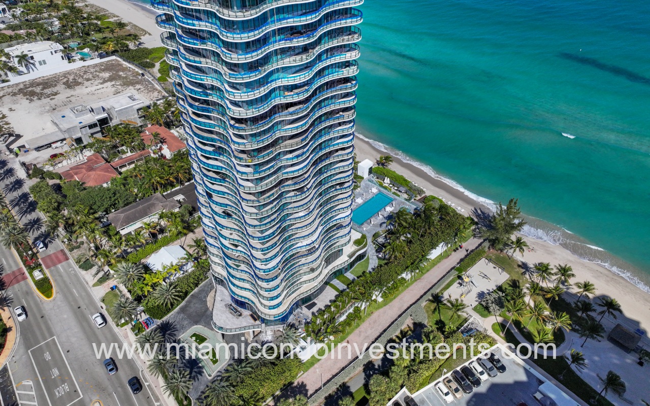 Regalia drone closeup overlooking condo building side and blue ocean