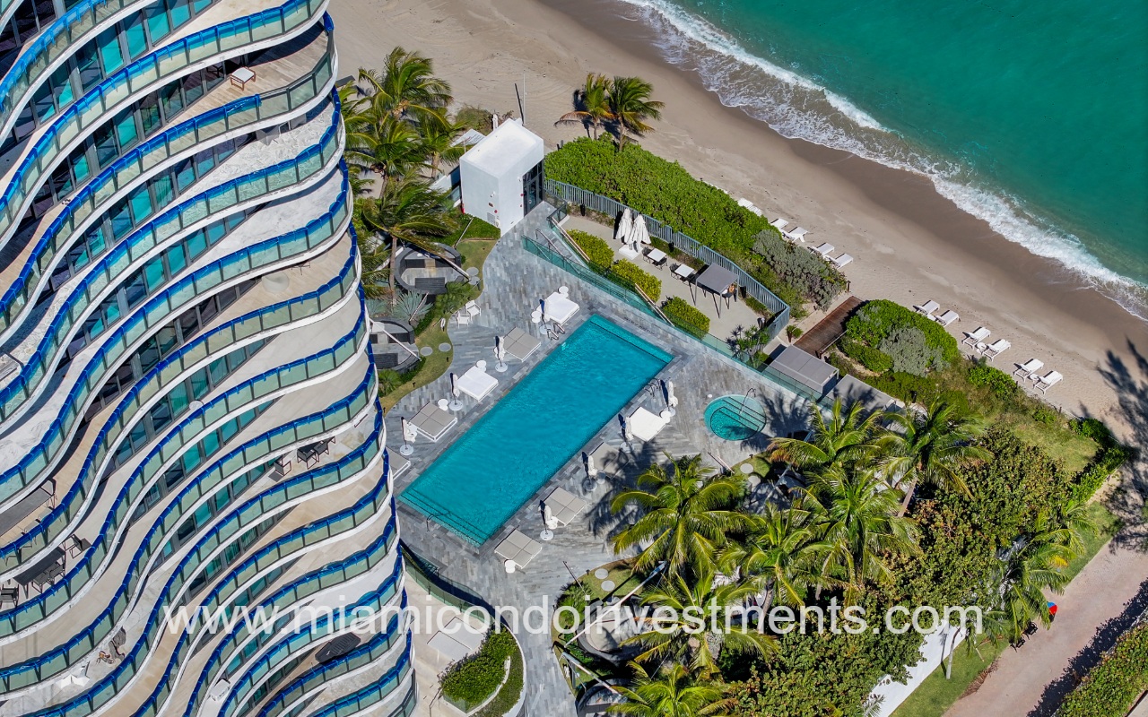 Regalia drone overlooking condo building pool by the beach