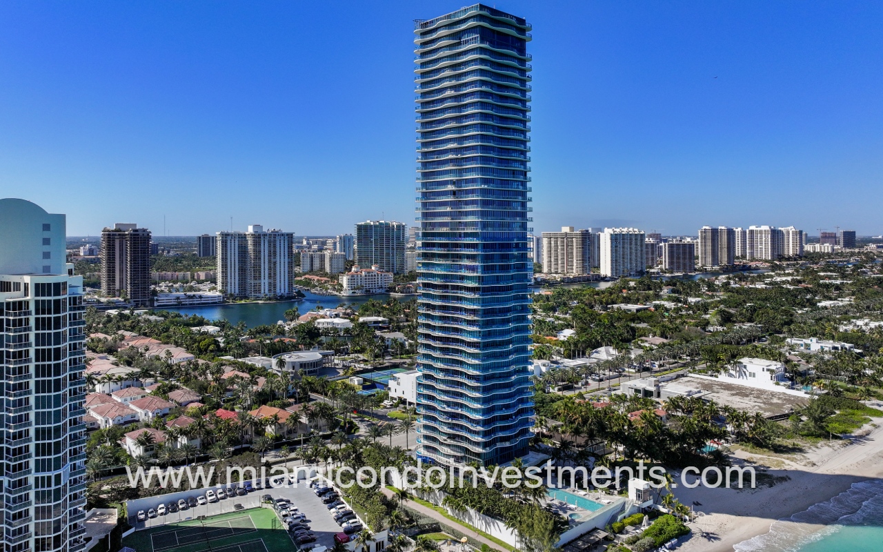 Regalia drone facing condo building angle view with area buildings in background