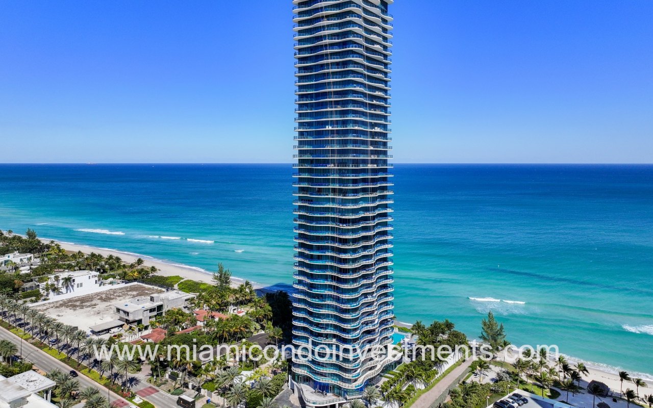 Regalia drone closeup facing condo building on blue ocean