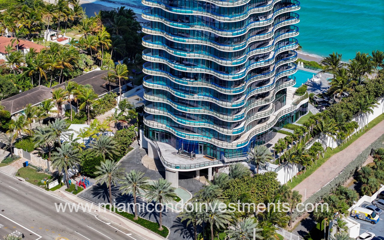Regalia drone closeup facing lower front exterior of condo building and entry