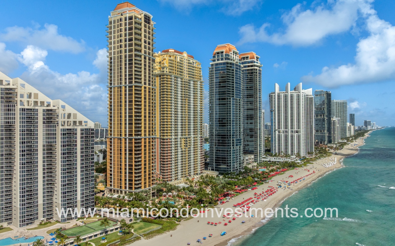 The Mansions at Acqualina drone view facing northward at condo building and buildings along shoreline