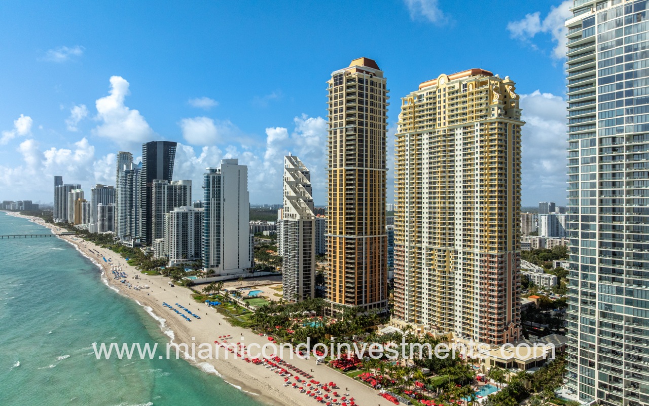 The Mansions at Acqualina drone of condo building and buildings on the ocean shoreline