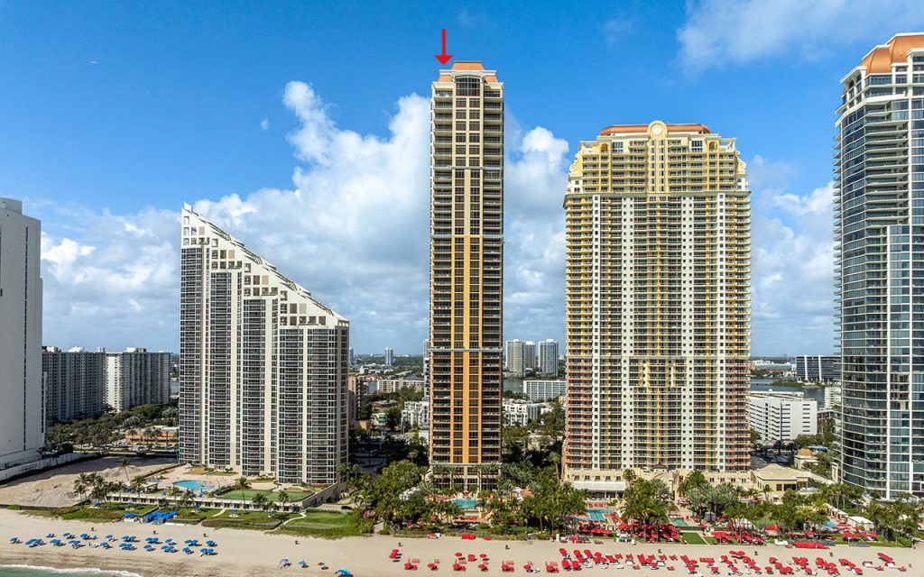 The Mansions at Acqualina drone view directly facing the condo building from above ocean