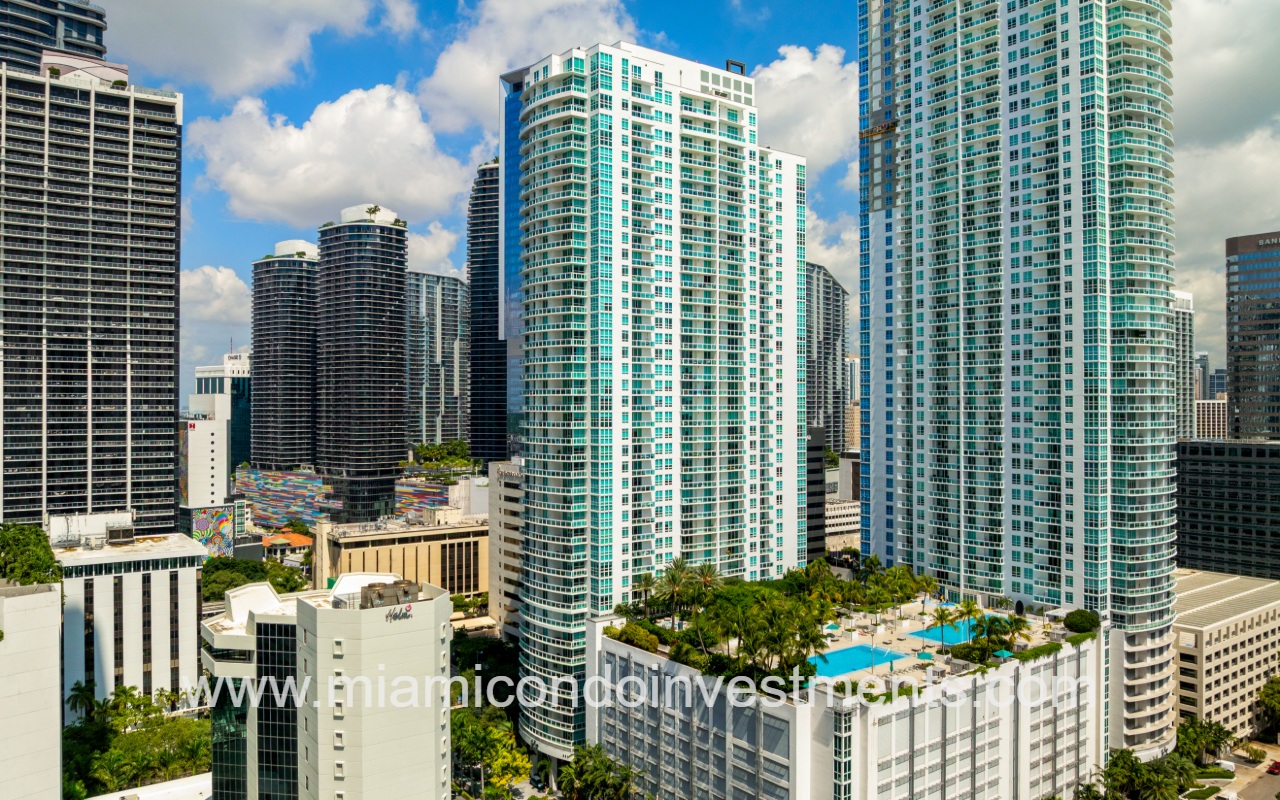 The Plaza Brickell East drone closeup view of condo building with pool
