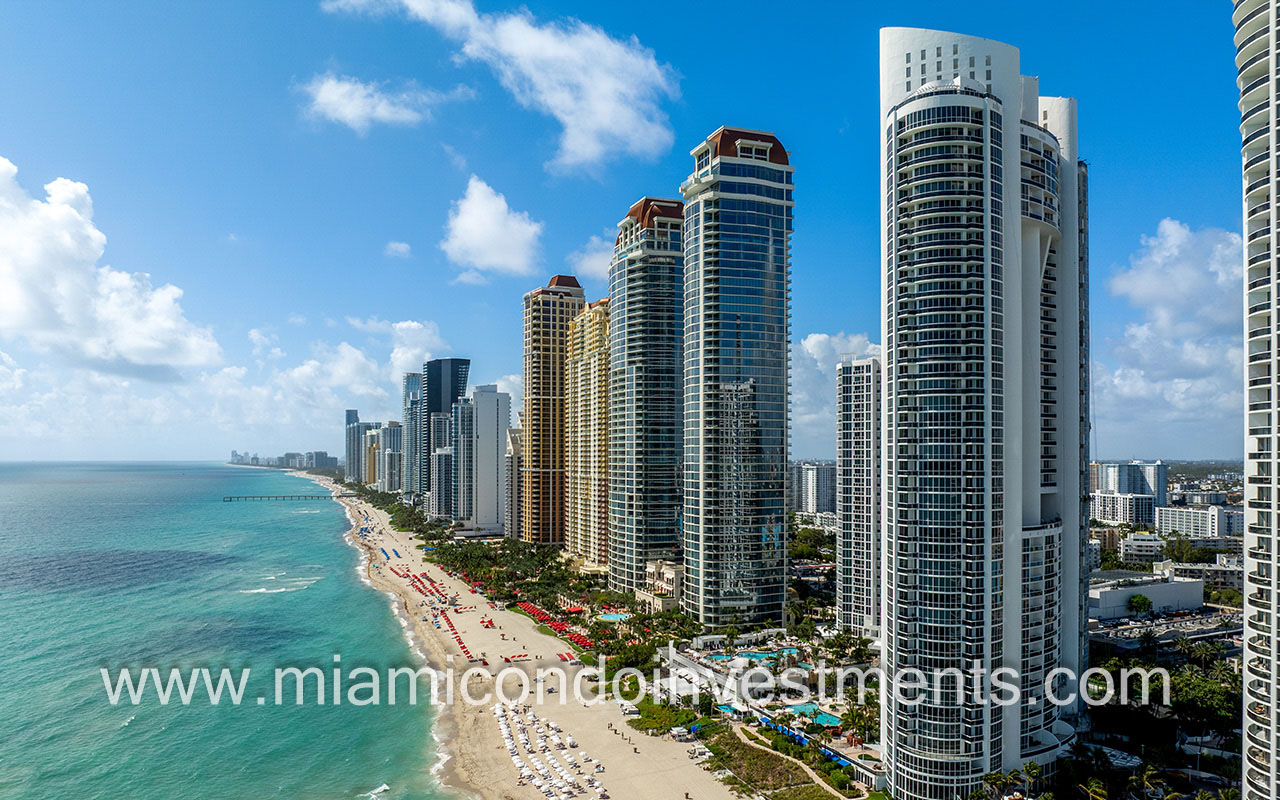 Trump Palace drone facing back side of building and South ocean shoreline direction