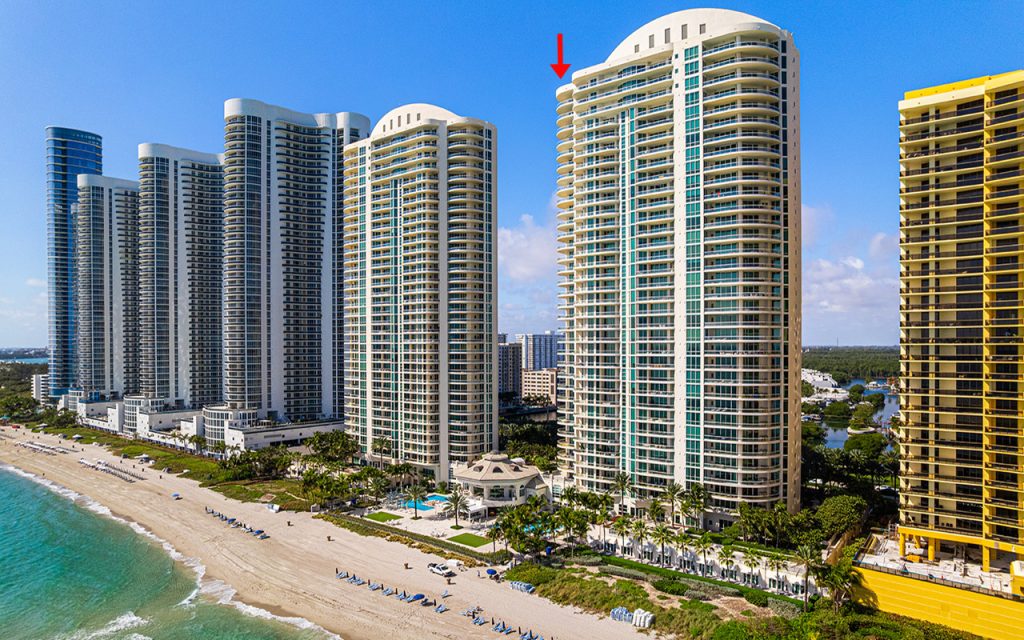 Turnberry Ocean Colony North drone view directly facing condo building from above the ocean