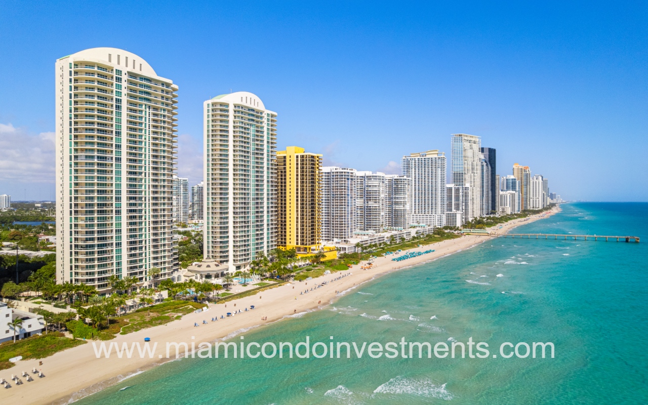 Turnberry Ocean Colony North drone overlooking condo buildings and ocean shoreline