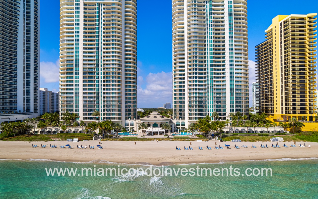 Turnberry Ocean Colony South drone closeup view directly facing lower half of condo building and beach