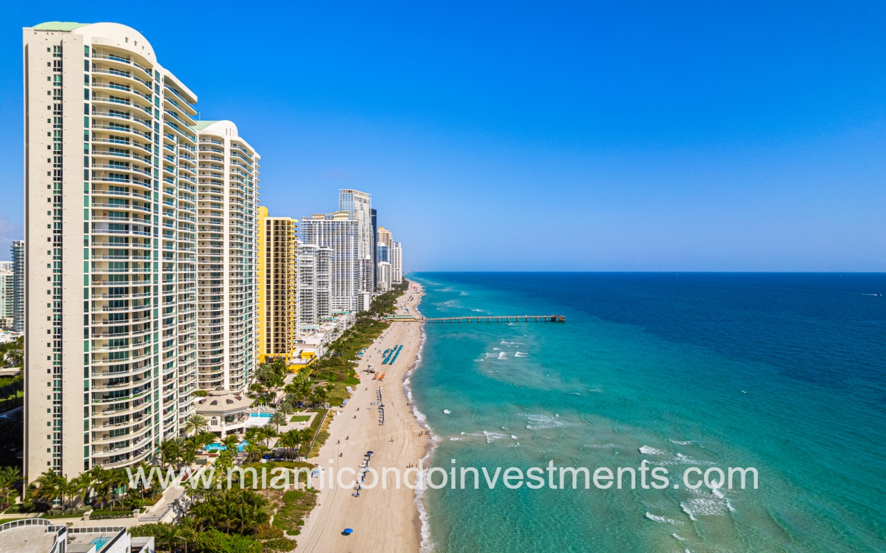 Turnberry Ocean Colony South drone profile building vie facing northward with condo building and blue ocean