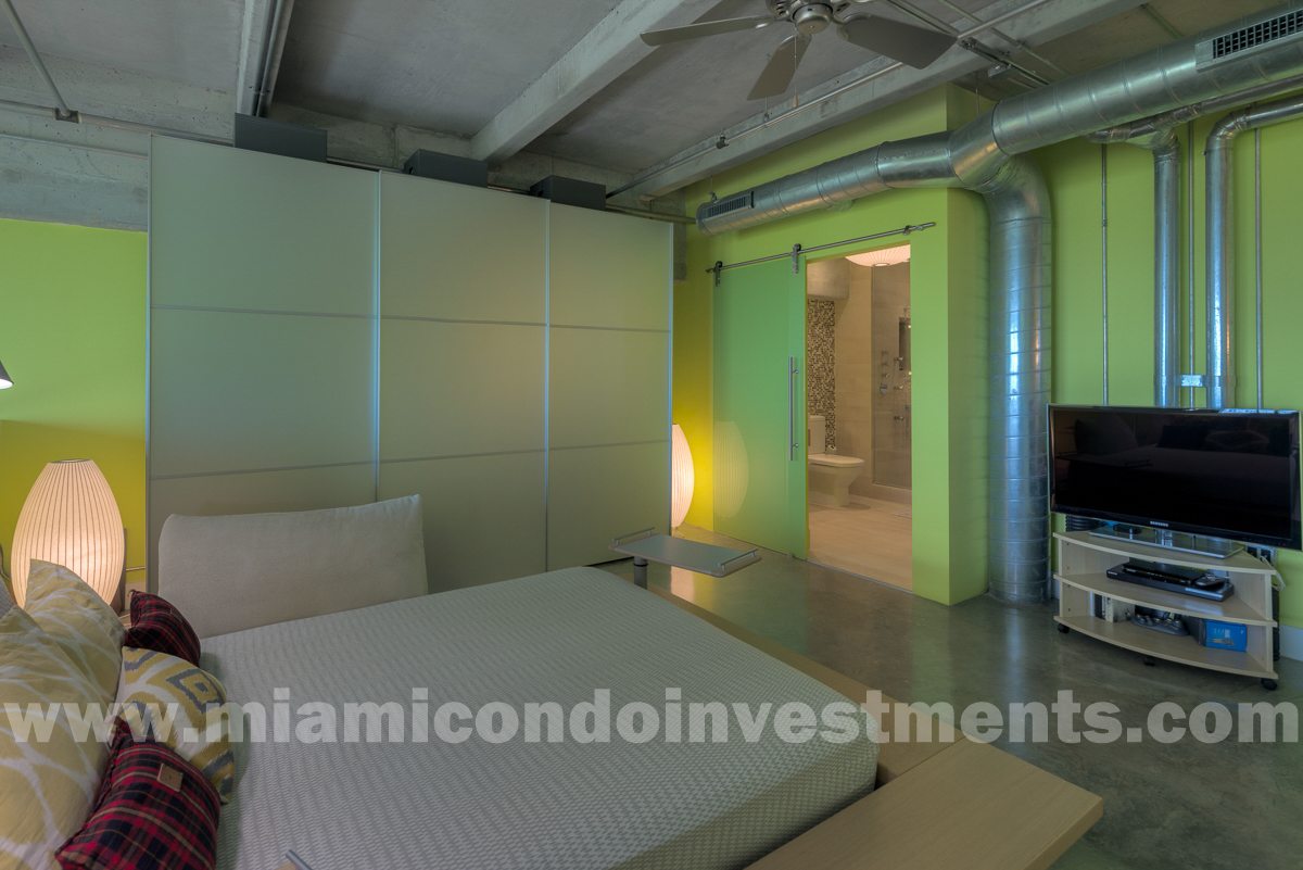 Peter Maly platform bed by Ligne Roset with custom latex foam mattress. Salvarani closet with platinum frosted glass doors.
