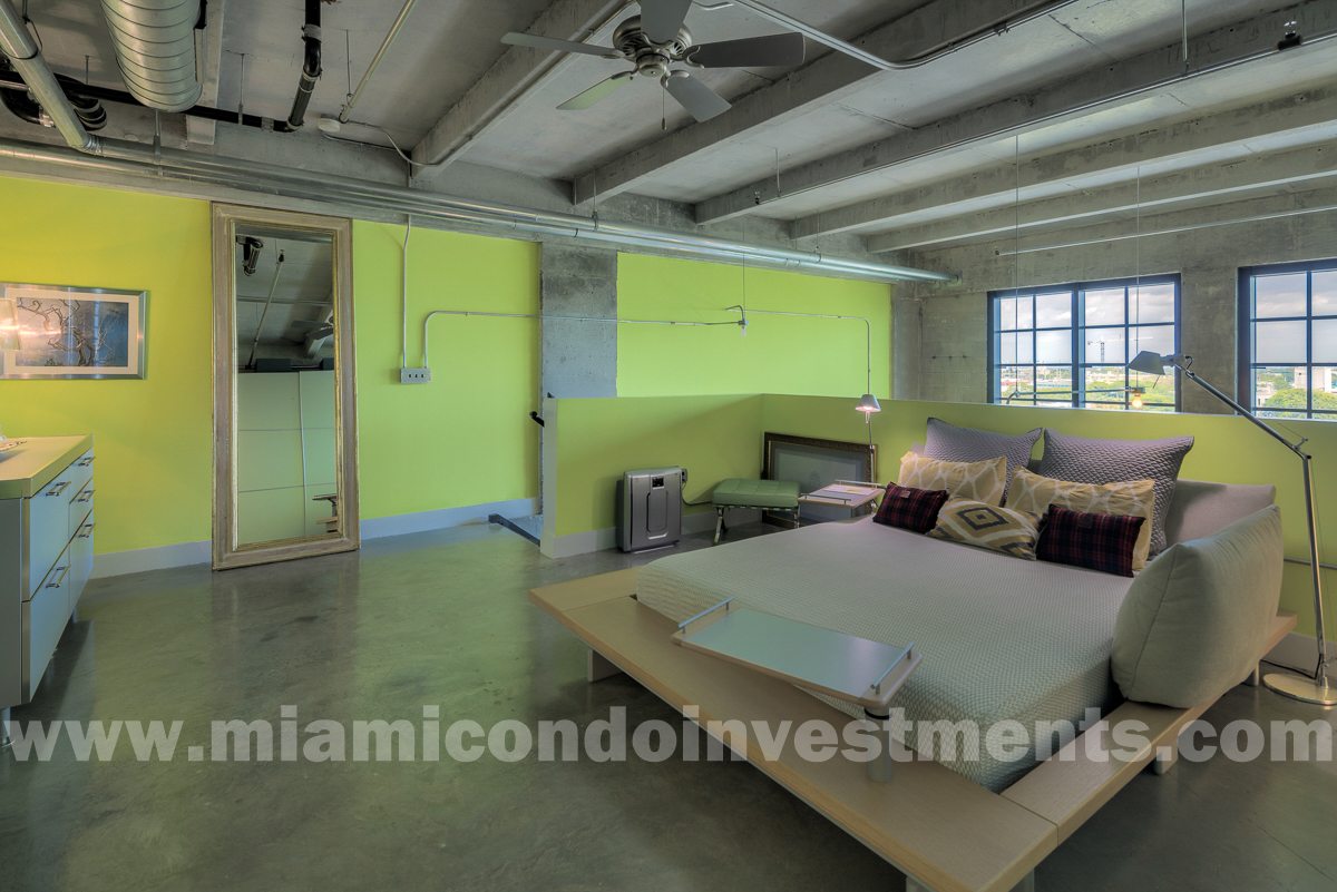 Peter Maly platform bed by Ligne Roset with custom latex foam mattress. Anthropologie tall mirror. Sharron Lewis green leather ottoman.