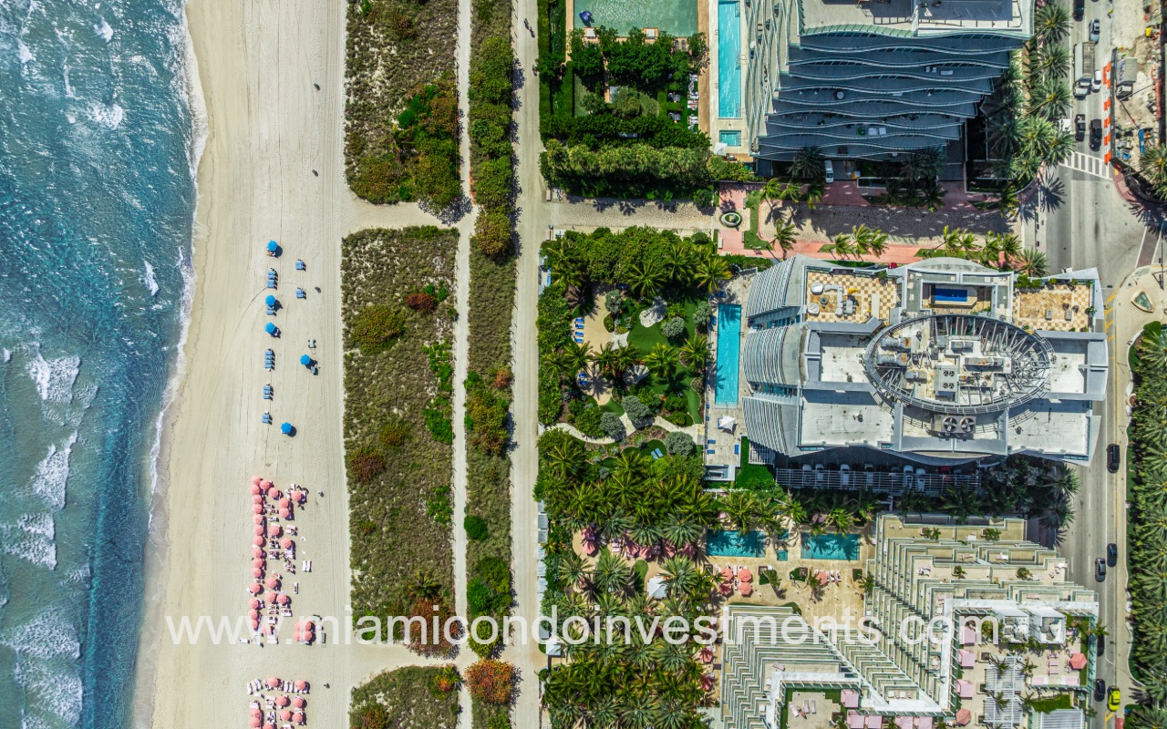 Azure drone downward view of condo building roof and beach