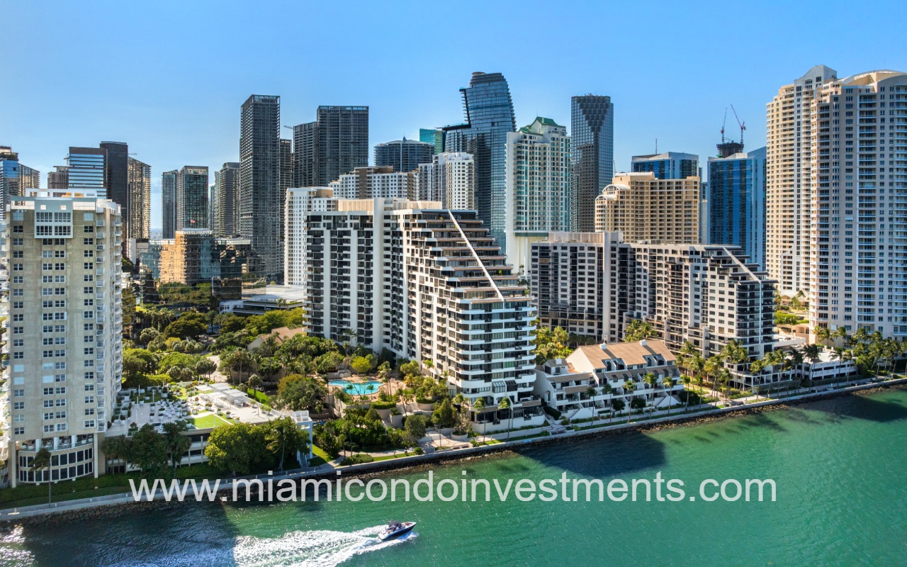 Brickell Key One aerial direct view of building and boat passing waterway