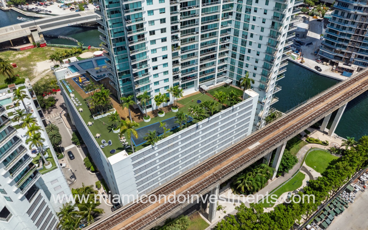 Mint condominium building with drone overlooking building terrace