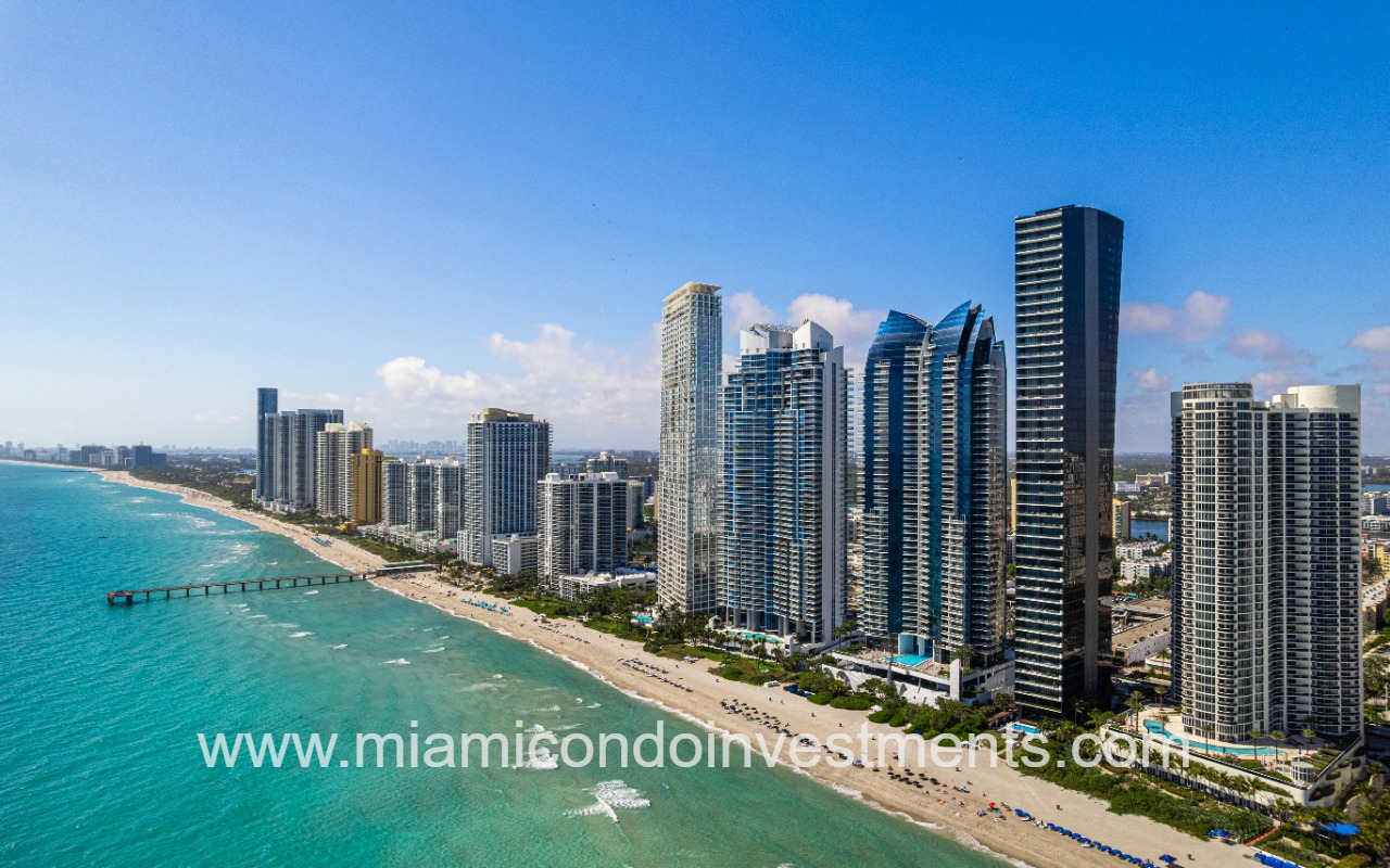 Muse drone long shot of beach shoreline and condo buildings skyline