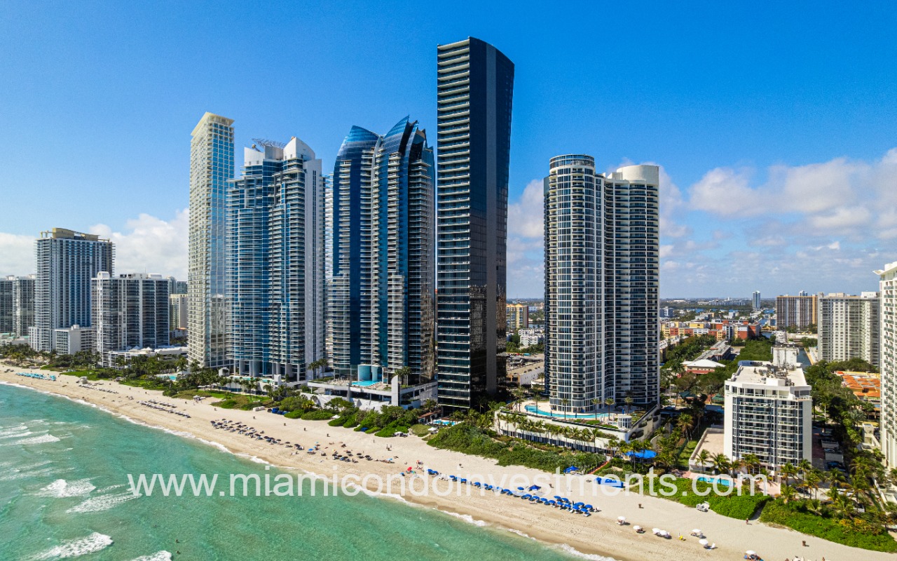 Muse drone of condo building and beach from ocean