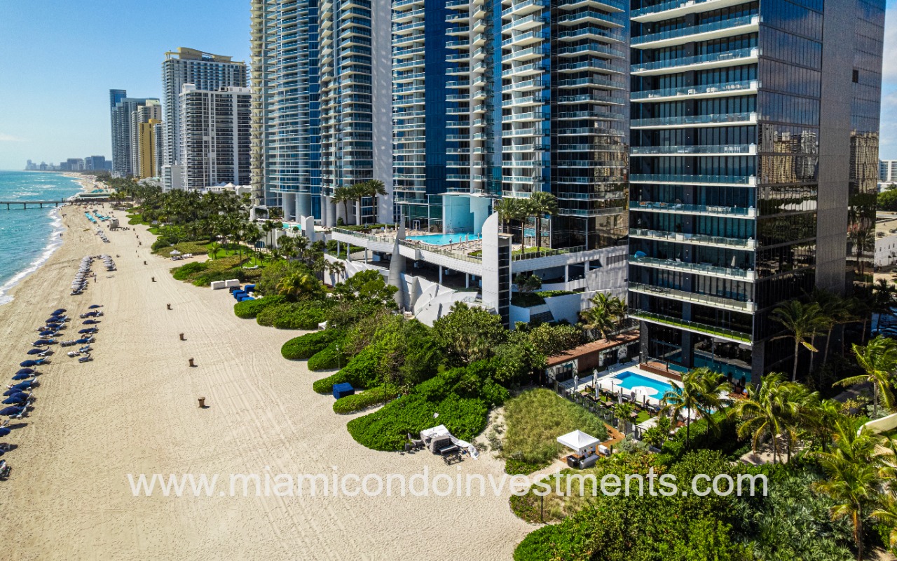 Muse drone of condo building lower exterior on beach