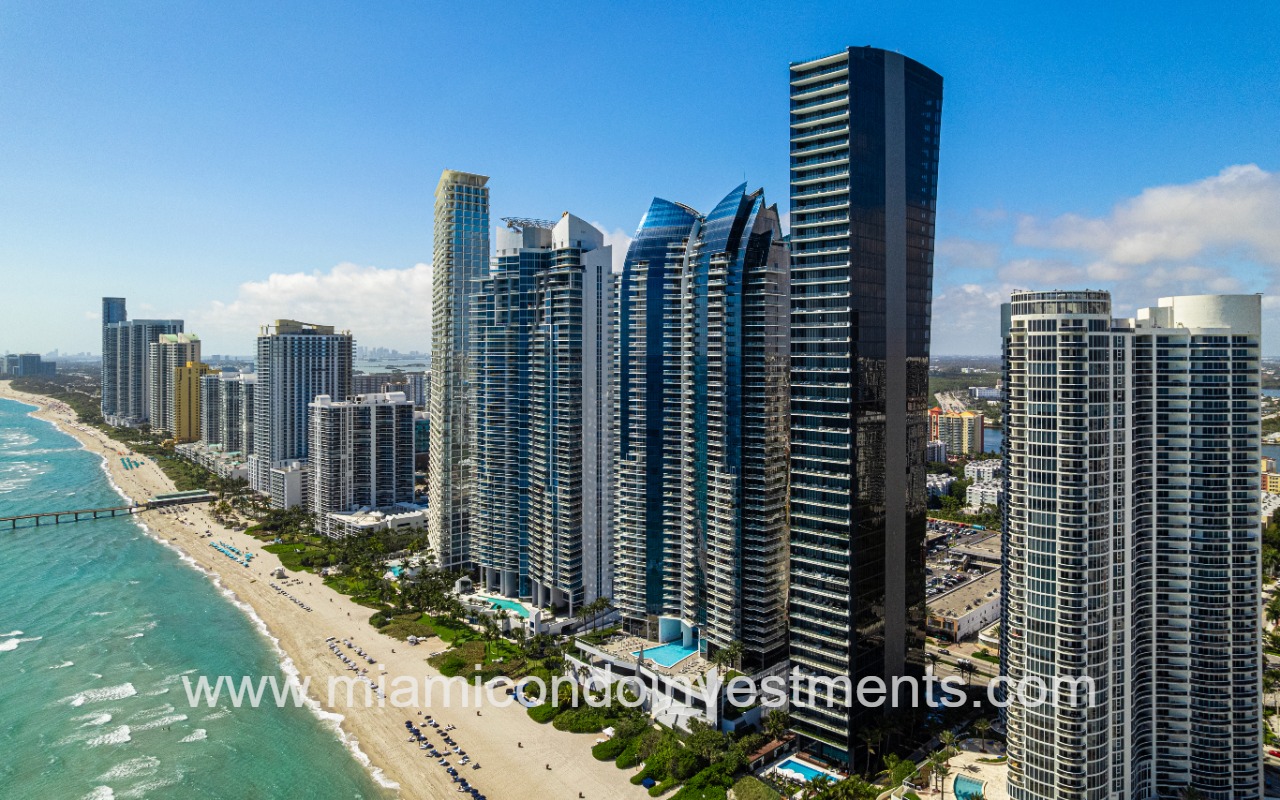 Muse drone angle view of condo building closeup and beach