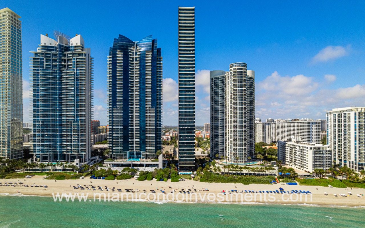 Muse drone facing condo and beach shoreline building from ocean