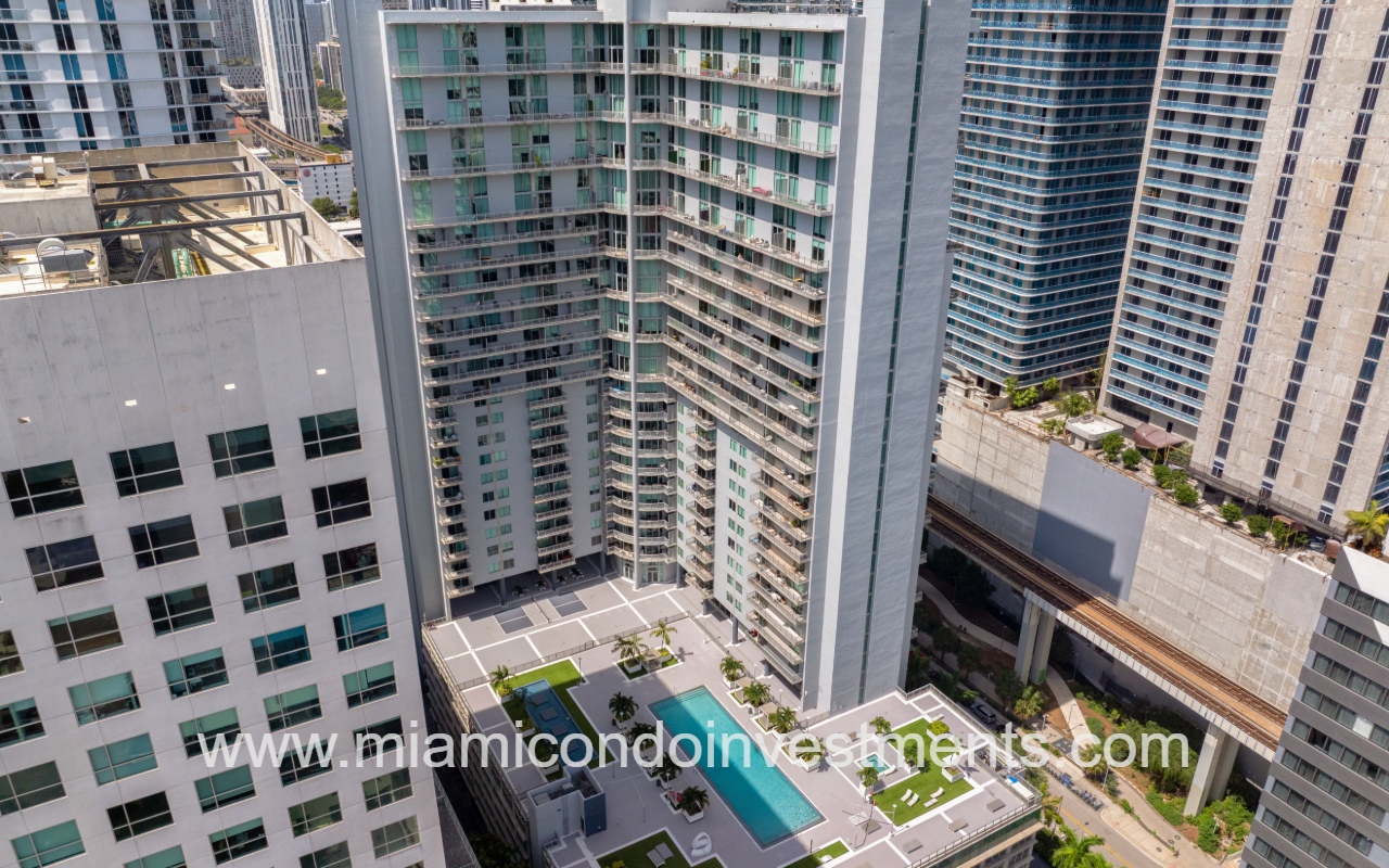 Neo Vertika drone overlooking pool and condo building