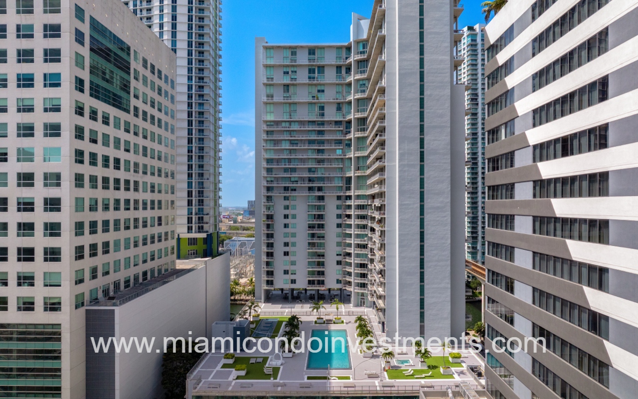 Neo Vertika drone side view of pool and condo building