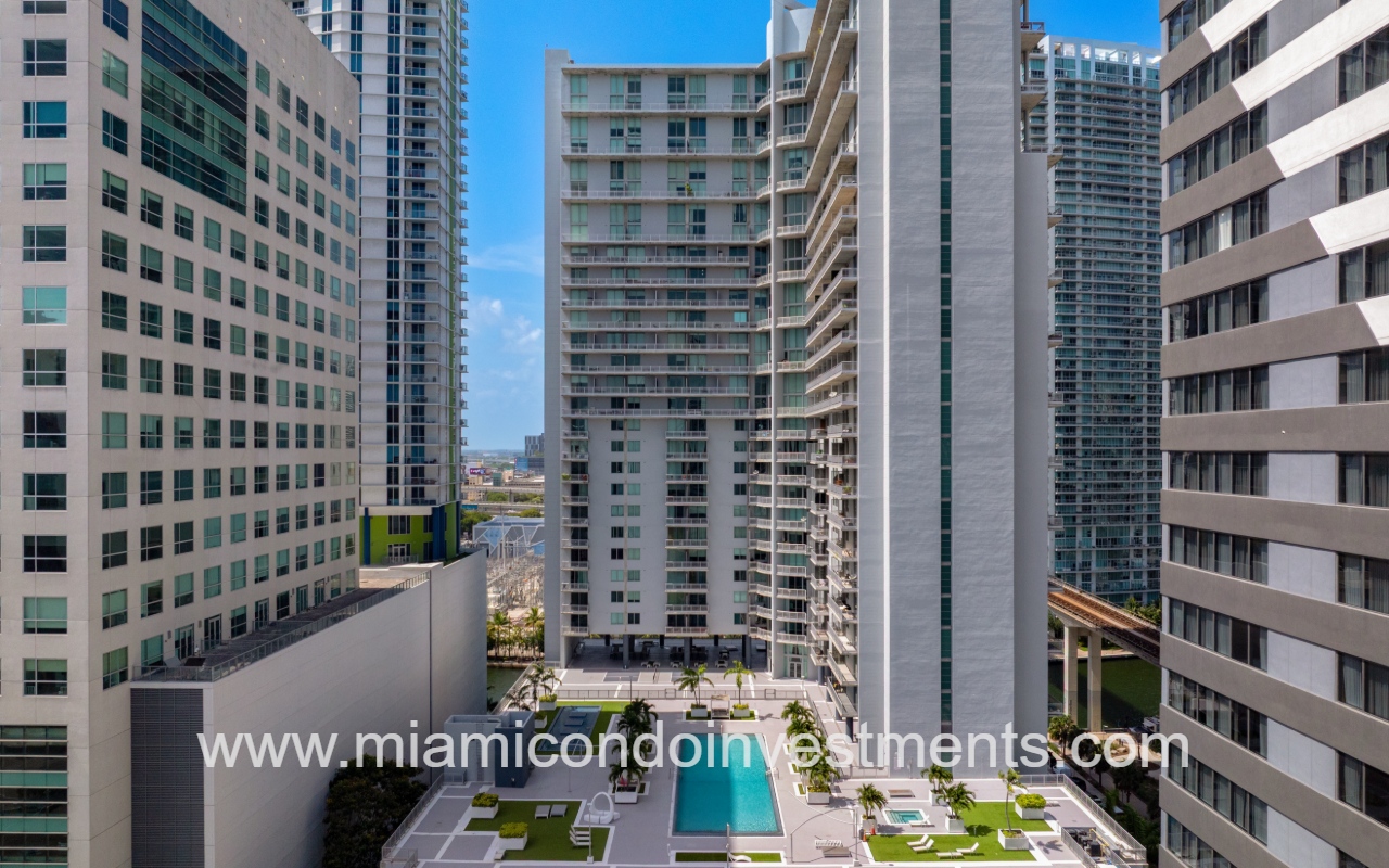 Neo Vertika drone close side view of pool and condo building