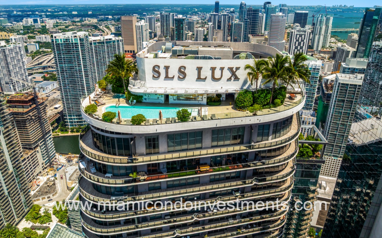 SLS Lux drone of condo building rooftop pool with view of area city buildings