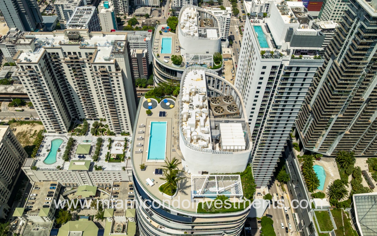 SLS Lux drone overlooking the condo building rooftop pool and city