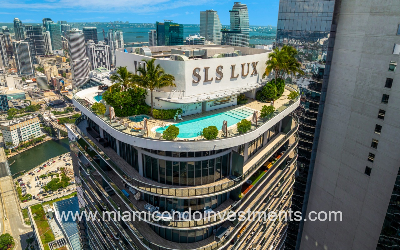 SLS Lux drone overlooking condo building corner with rooftop pool