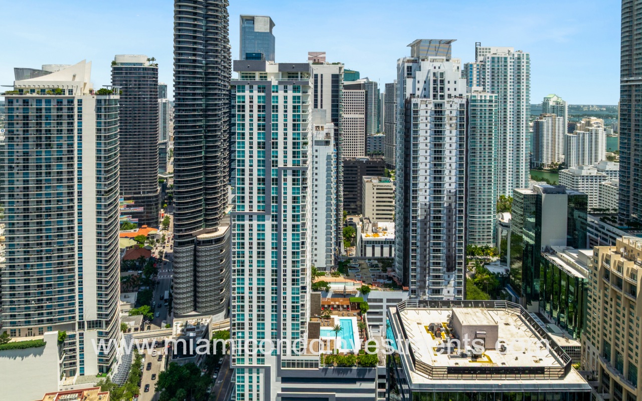 The Bond on Brickell drone view of condo building side profile and city